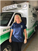 EMS staff member in front of ambulance