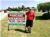 EMS staff member posing by pancake breakfast sign