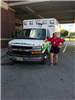 EMS staff member with arm on ambulance