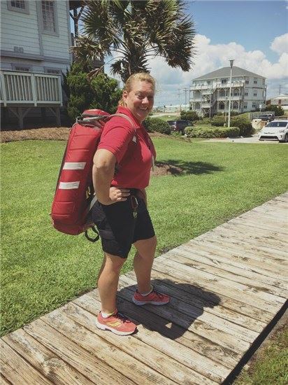 EMS staff member carrying equipment