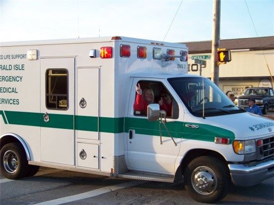 EMS staff member giving a peace sign in an ambulance