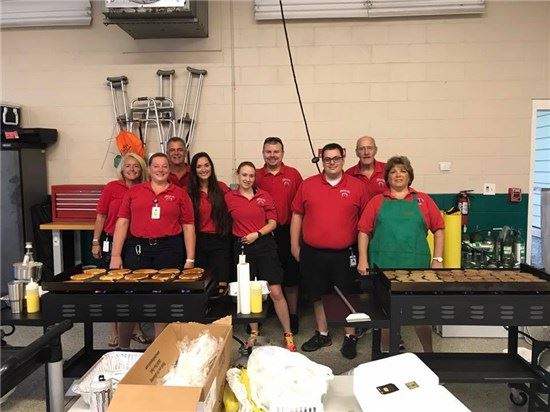EMS staff members cooking for pancake feed
