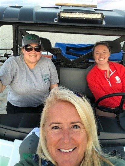 EMS staff posing in an ATV