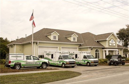 EMS vehicles and ATV in front of building