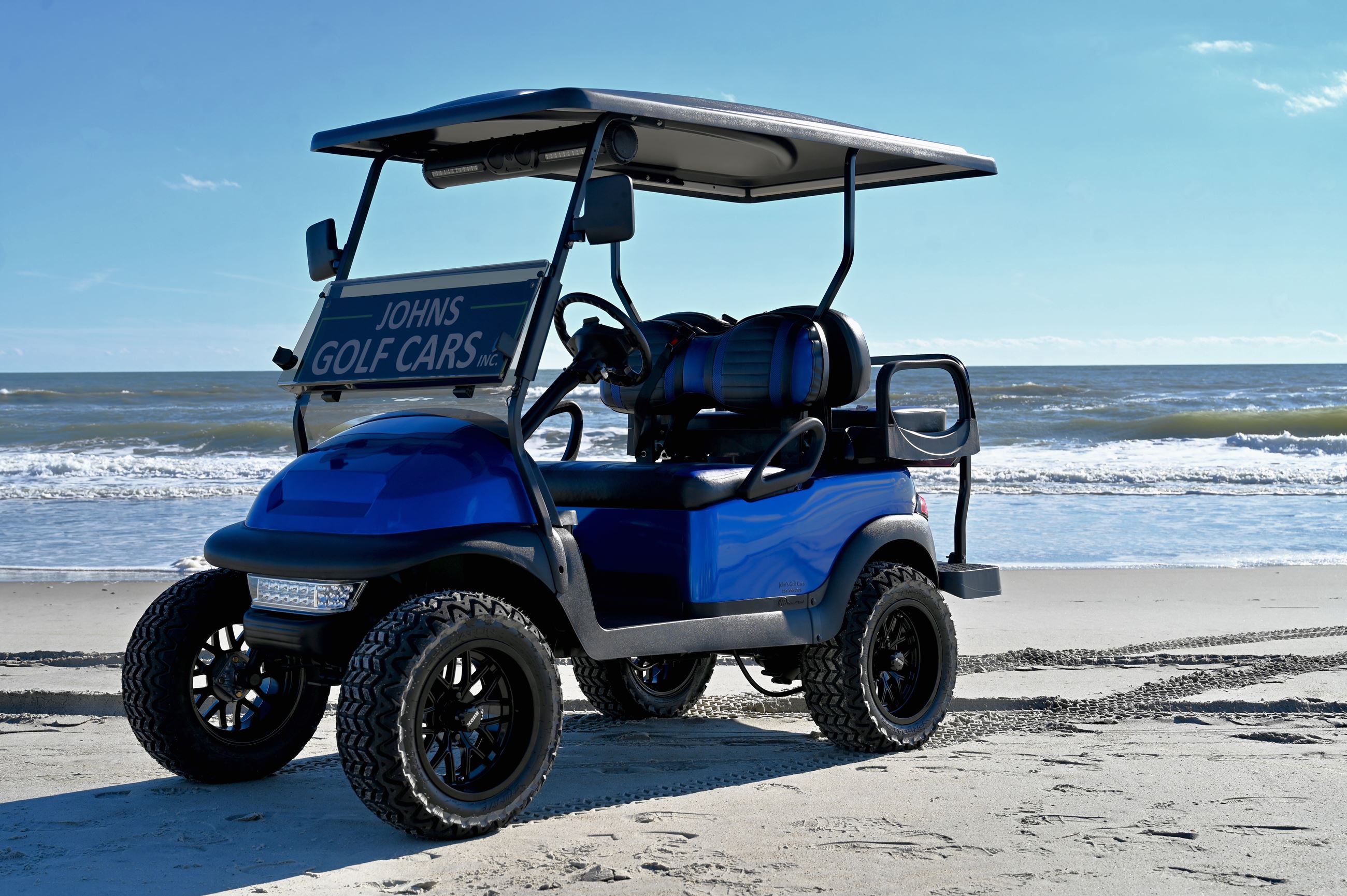 Blue golf cart on beach